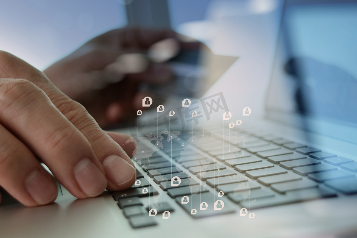 close up of hands using laptop and holding credit card with soci图片