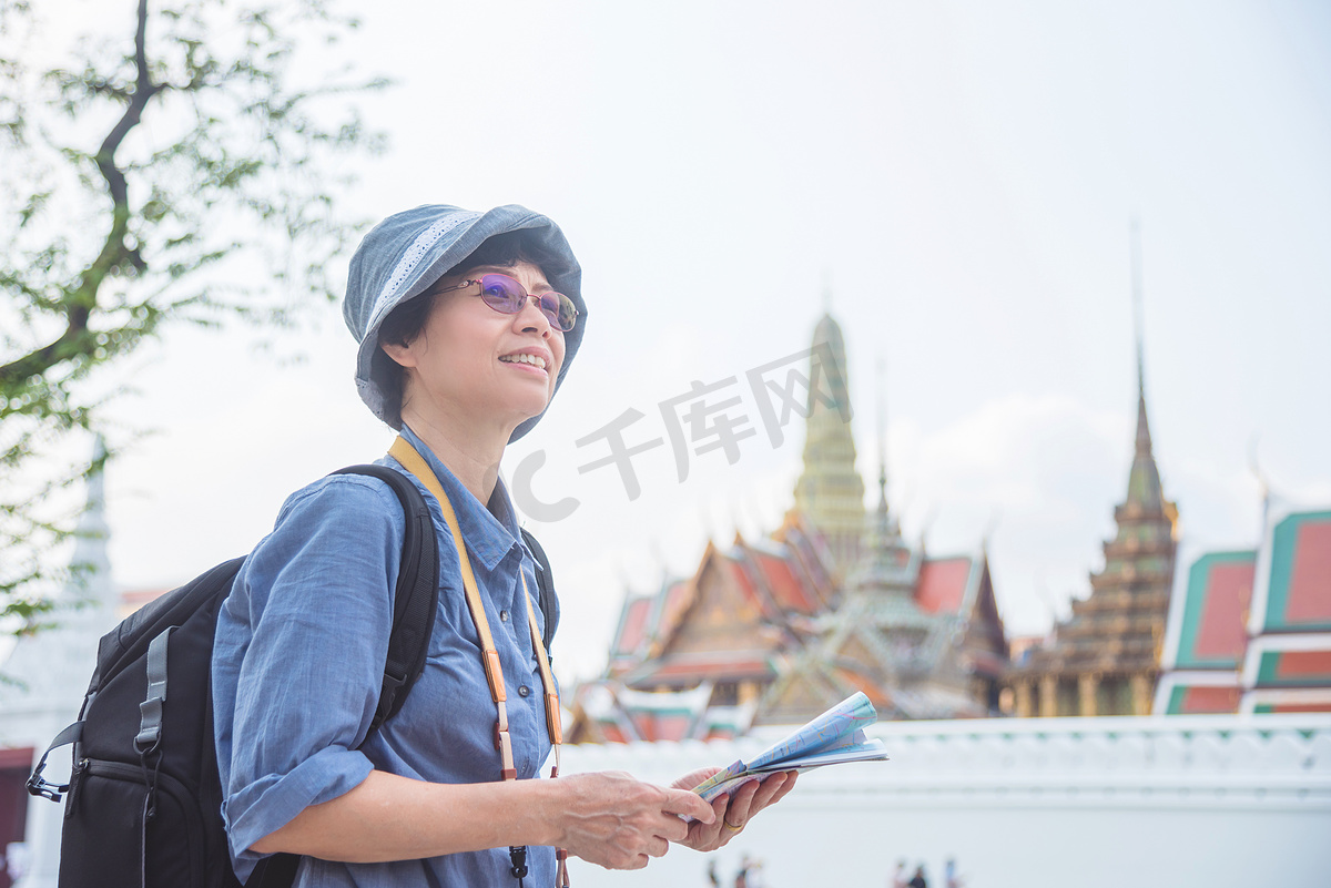 高级女游客拿着纸质地图在泰国旅游图片