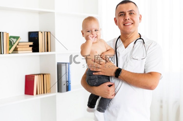 微笑的医生抱着可爱的小宝宝
