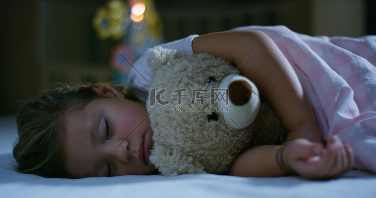 宝宝休息静静地躺在床上抱着泰迪