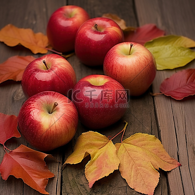 苹果和秋天的树叶在木背景上