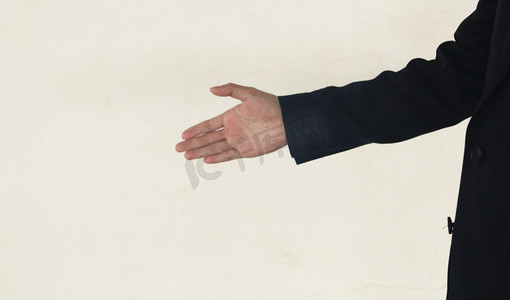 伸出手想要握手的商务人士摄影图