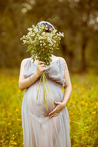 三八妇女节展板摄影照片_女神节妇女节女性花丛里的孕妇