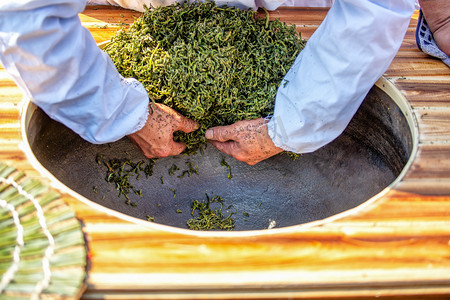 养生茶摄影照片_茶叶清晨手茶厂炒茶摄影图配图