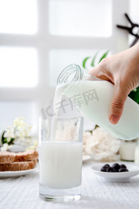 美食白天牛奶窗户前倒牛奶摄影图配图