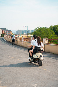 城市午后情侣公路骑车摄影图配图