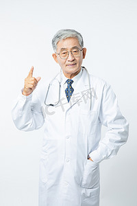 摄影照片_医疗医生白天穿着白大褂的男医生室内手指抬起来摄影图配图人物