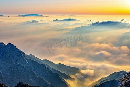 云雾日出摄影照片_冬日旅行凌晨雪山山区飘动摄影图配图