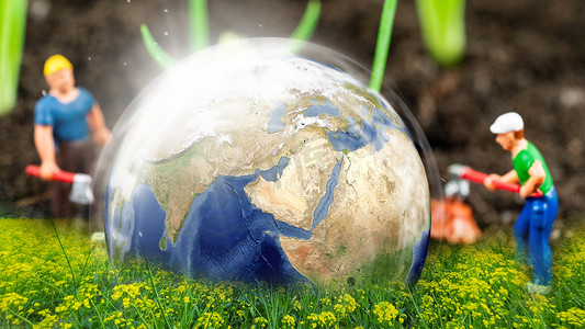 立体环保箭头摄影照片_绿色环保共建家园保护地球白天环保地球植物劳动摄影图配图