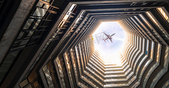 商务飞机摄影照片_企业文化企业精神希望远方白天高楼大厦飞机飞行摄影图配图