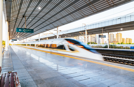 站台摄影照片_站台上高速驶出的高铁列车摄影图配图