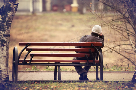 安静摄影照片_孤独的人上的长椅上秋雨