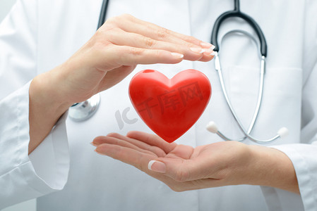医药文字框摄影照片_一双保护心脏的医生的手特写