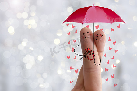 艺术概念的手指。情人是拥抱和控股红伞和花束的心。股票的图像