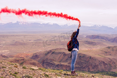 红色的烟雾在山上的女孩