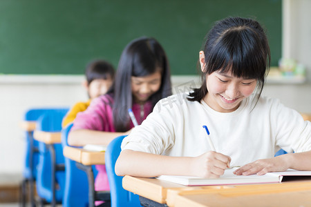 在教室里学习的快乐少女学生儿童