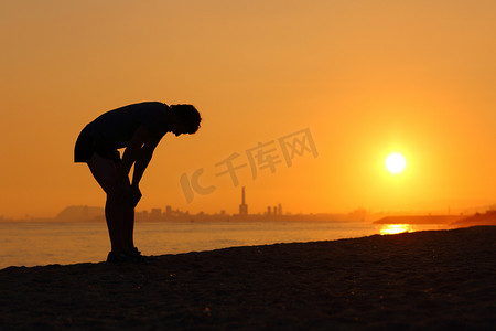 累了的运动员，在日落时的剪影