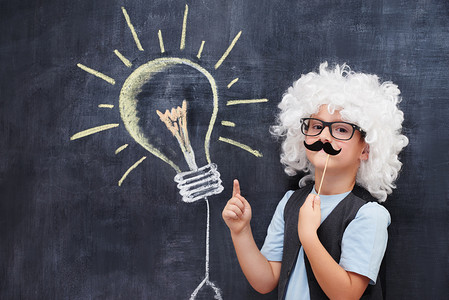 Portrait of male elementary school student in Einstein costume