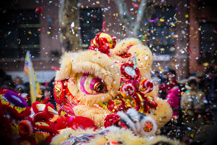 庆祝摄影照片_舞狮子和纸屑在中国新年庆祝活动期间 