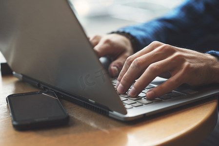 Close up shot of hands typing on laptop