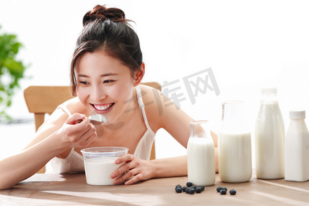 吃酸奶摄影照片_青年女人喝牛奶