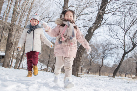 冬天小朋友摄影照片_两个小朋友在雪地里玩耍
