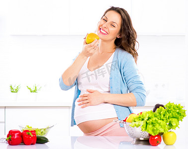 孕妇饮食摄影照片_年轻孕妇吃苹果.