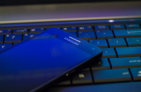 The Samsung Galaxy A5 laying on laptop keyboard
