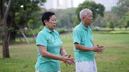 健身气功摄影照片_亚洲高级老年夫妇练习太极，气功锻炼 ou