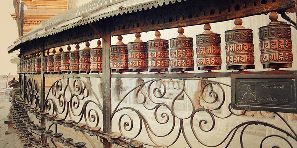 Tibetan Prayer Wheels with mantras near Swayambhunath Stupa - vintage photo.