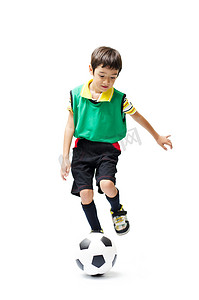 小男孩踢足球绿色白色背景上