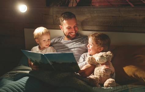 晚上家庭读书。父亲读孩子。前一本书
