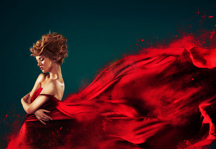 溶解摄影照片_红吹飞溶解在飞溅的红裙子的女人