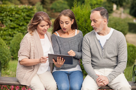 Pretty friendly family is using laptop for fun