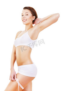 健身背景摄影照片_快乐健康的女孩，白色背景上的卷尺