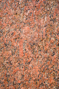 粗糙的红色花岗岩火成岩的石头背景