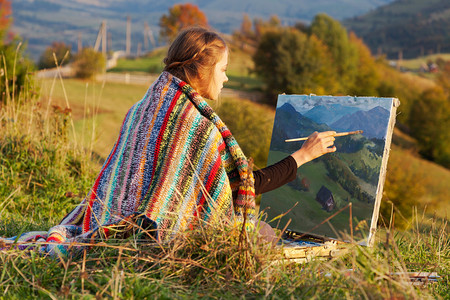 年轻的画家画着秋天的风景