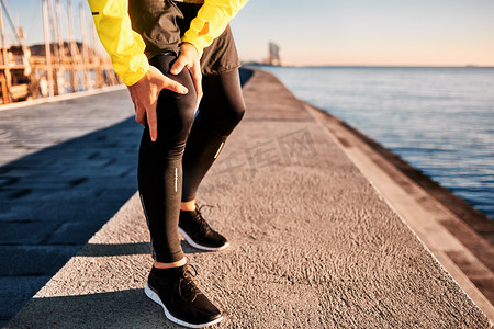 Knee Injury - sports running knee injuries on man. Close up of legs, muscle and knee outdoors. Male fitness athlete runner with pain from sprain knee. 