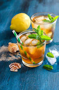 Fresh cold iced tea with mint, ice and lemons, refreshing drink