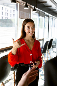smiley businesswoman using sign language work