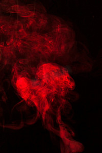 冒烟的茶杯摄影照片_红色烟雾碎片设计黑色背景
