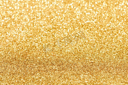 金色扭纹戒指摄影照片_闪亮的金bokeh闪光的光抽象背景，圣诞节新年聚会庆祝概念。闪亮的金色灯光背景