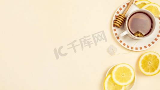红茶与切片新鲜柠檬米色背景