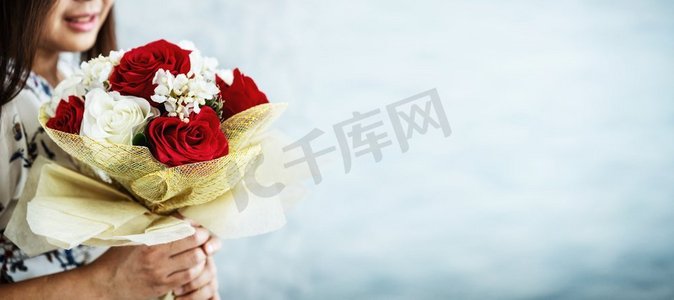送玫瑰摄影照片_情人节那天，快乐的女人收到男友送的玫瑰花束礼物。夫妻相爱的生活方式理念。