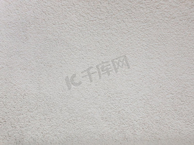 空白混凝土墙体，白色水泥为肌理抽象的背景。结构之间饱经风化的浅灰色垃圾。
