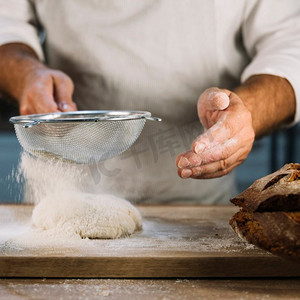 面包师用钢筛选小麦粉
