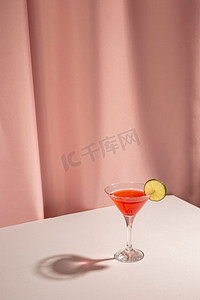 半透明糊状摄影照片_新鲜玛格丽塔鸡尾酒饮料柠檬片桌子对粉红色窗帘