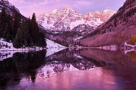 美国科罗拉多州落基山脉，秋天的日出时分，栗色的钟声和栗色的湖水在雪地里反射岩石和山脉。