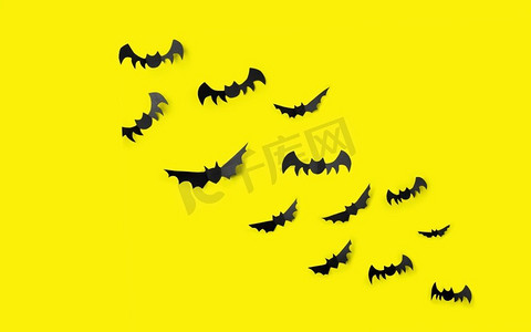 神秘聚会摄影照片_万圣节，装饰和可怕的概念-成群的黑色纸蝙蝠飞过黄色的背景。黄色背景上的一群黑色纸蝙蝠