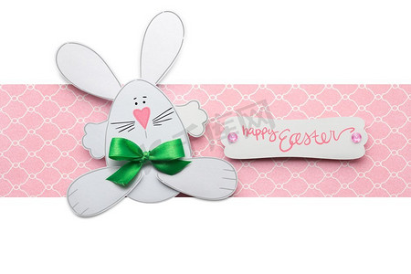 复活节照片摄影照片_富有创意的复活节概念照片，一只粉白色背景的纸做的兔子。